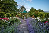 THE MANOR HOUSE, BLEDLOW, BUCKINGHAMSHIRE: MAY, THE WALLED KITCHEN, VEGETABLE GARDEN, PEONIES, CATMINT AND ROSE PHYLLIS BIDE CLIMBING UP CENTRAL GAZEBO
