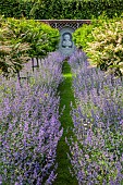 THE MANOR HOUSE, BLEDLOW, BUCKINGHAMSHIRE: MAY, MURAL OF VERTUMNUS IN THE MANNER OF ARCHIMBOLDO BY OWEN TURVILLE, STANDARD PRUNUS LUSITANICA, NEPETA WALKERS LOW, PATH, VISTA