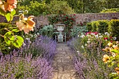 THE MANOR HOUSE, BLEDLOW, BUCKINGHAMSHIRE: MAY, THE WALLED KITCHEN, VEGETABLE GARDEN, PEONIES, CATMINT, PATH, URN, ROSE HIGHGROVE