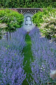 THE MANOR HOUSE, BLEDLOW, BUCKINGHAMSHIRE: MAY, MURAL OF VERTUMNUS IN THE MANNER OF ARCHIMBOLDO BY OWEN TURVILLE, STANDARD PRUNUS LUSITANICA, NEPETA WALKERS LOW, PATH, VISTA