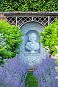 THE MANOR HOUSE, BLEDLOW, BUCKINGHAMSHIRE: MAY, MURAL OF VERTUMNUS IN THE MANNER OF ARCHIMBOLDO BY OWEN TURVILLE, STANDARD PRUNUS LUSITANICA, NEPETA WALKERS LOW, PATH, VISTA