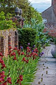 THE MANOR HOUSE, BLEDLOW, BUCKINGHAMSHIRE: MAY, WALLED GARDEN, ROW OF IRIS KENT PRIDE BESIDE THE WALL, PATH