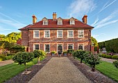 THE MANOR HOUSE, BLEDLOW, BUCKINGHAMSHIRE: MAY, THE MANOR HOUSE WITH STANDARD VIBURNUM CARLESII AURORA ALONGSIDE TH GRAVEL PATH