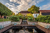 THE MANOR HOUSE, BLEDLOW, BUCKINGHAMSHIRE: MAY, SUNKEN POOL GARDEN, WALLS, WATER, FOUNTAIN, SCULPTURE BY MAX MADDOCKS, CORNUS CONTROVERSA PAGODA