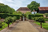 THE MANOR HOUSE, BLEDLOW, BUCKINGHAMSHIRE: MAY, 18TH CENTURY GRANARY ON STADDLE STONES, SUNKEN POOL GARDEN, PATH, STANDARD VIBURNUM CARLESII AURORA
