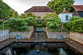 THE MANOR HOUSE, BLEDLOW, BUCKINGHAMSHIRE: MAY, SUNKEN POOL GARDEN, WALLS, WATER, FOUNTAIN, SCULPTURE BY MAX MADDOCKS, CORNUS CONTROVERSA PAGODA