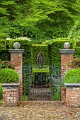 THE MANOR HOUSE, BLEDLOW, BUCKINGHAMSHIRE: MAY, VIEW THROUGH GATES TO THE SCULPTURE GARDEN BEYOND