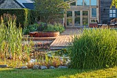 TYTHE BARN, OXFORDSHIRE, DESIGNER SARAH NAYBOUR: JUNE, WILDLIFE POND, DECKING, LAWN, POOL, WATER, WOODEN JACUZZI