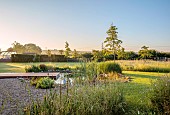 TYTHE BARN, OXFORDSHIRE, DESIGNER SARAH NAYBOUR: JUNE, WILDLIFE POND, DECKING, LAWN, POOL, WATER