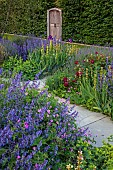 TYTHE BARN, OXFORDSHIRE, DESIGNER SARAH NAYBOUR: JUNE, BORDERS IN PURPLE AND YELLOW, IRIS SULTRY MOOD, SALVIA NEMEROSA CARADONNA, SISYRINCHIUM STRIATUM, BEECH HEDGE, VINTAGE DOOR