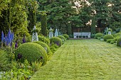 OLD BLADBEAN STUD GARDENS, KENT: JUNE, MIRRORED BORDERS, LAWN, STONE SEAT, OBELISKS, DELPHINIUMS