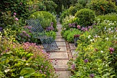 OLD BLADBEAN STUD GARDENS, KENT: JUNE, THE ROSE GARDEN, PATH, METAL SEAT, PHUOPSIS STYLOSA, ALLIUM CHRISTOPHII, SEDUMS, GERANIUM PRATENSE F ALBUM