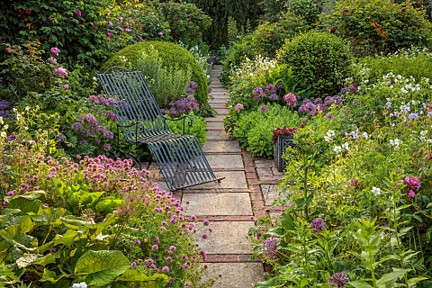 OLD_BLADBEAN_STUD_GARDENS_KENT_JUNE_THE_ROSE_GARDEN_PATH_METAL_SEAT_PHUOPSIS_STYLOSA_ALLIUM_CHRISTOP