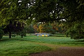 COTTESBROOKE HALL AND GARDENS, NORTHAMPTONSHIRE: THE MITCHELL BRIDGE, WATER, LAKE, SUNRISE, JUNE