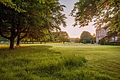 COTTESBROOKE HALL AND GARDENS, NORTHAMPTONSHIRE: JUNE, DAWN, SUNRISE, THE WEST FRONT, MIST, FOG, LAWN, PARKLAND