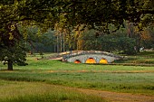 OTTESBROOKE HALL AND GARDENS, NORTHAMPTONSHIRE: THE MITCHELL BRIDGE, WATER, LAKE, SUNRISE