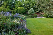 MORTON HALL GARDENS, WORCESTERSHIRE: JUNE, BORDERS, PEROVSKIA, ROSES, BLUE FLOWERS OF CAMPANULA PRITCHARDS VARIETY, LAWN, FOUNTAIN