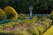 ROCKINGHAM CASTLE, NORTHAMPTONSHIRE: JUNE, THE CROSS GARDEN DESIGNED BY JOHN CODRINGTON, SUNDIAL, HYBRID TEA ROSE AMAZING GRACE, LAVENDER, NEPETA