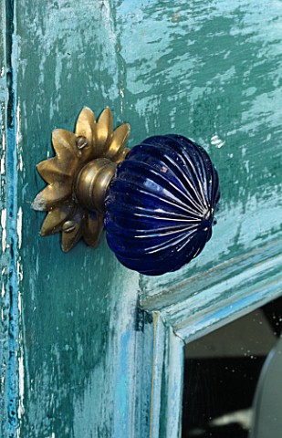 GLASS_DOOR_HANDLES_ON_BLUE_DISTRESSED_DOOR__AS_USED_BY_GARDEN_DESIGNER_ANTHONY_NOEL