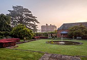 COTTESBROOKE HALL AND GARDENS, NORTHAMPTONSHIRE: DAWN, SUNRISE, THE POOL GARDEN, FOUNTAIN, POND, WATER, LAWN, CEDAR OF LEBANON