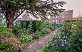 COTTESBROOKE HALL AND GARDENS, NORTHAMPTONSHIRE: THE TERRACE, DOUBLE HERBACEOUS BORDERS, PATH, YEW, VISTA, CEDAR OF LEBANON, ONOPORDUM ACANTHIUM, GERANIUMS, LUPINS