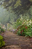 COTTESBROOKE HALL AND GARDENS, NORTHAMPTONSHIRE: THE TERRACE, DOUBLE HERBACEOUS BORDERS, ONOPORDUM ACANTHIUM, GERANIUMS, LUPINS