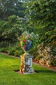 COTTESBROOKE HALL AND GARDENS, NORTHAMPTONSHIRE: LAWN, STONE CONTAINER WITH PELARGONIUM HAPPY FACE MAGENTA, NEMESIA KAROO PINK, PLECTRANTHUS ARGENTATUS