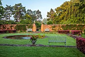 COTTESBROOKE HALL AND GARDENS, NORTHAMPTONSHIRE: DAWN, SUNRISE, THE POOL GARDEN, FOUNTAIN, POND, WATER, LAWN, CEDAR OF LEBANON, COPPER BEECH HEDGE, WALL, WALLED