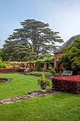 COTTESBROOKE HALL AND GARDENS, NORTHAMPTONSHIRE: DAWN, SUNRISE, THE POOL GARDEN, FOUNTAIN, POND, WATER, LAWN, CEDAR OF LEBANON, COPPER BEECH HEDGE, WALL, WALLED