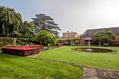 COTTESBROOKE HALL AND GARDENS, NORTHAMPTONSHIRE: DAWN, SUNRISE, THE POOL GARDEN, FOUNTAIN, POND, WATER, LAWN, CEDAR OF LEBANON, COPPER BEECH HEDGE, WALL, WALLED