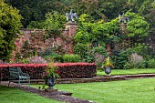 COTTESBROOKE HALL AND GARDENS, NORTHAMPTONSHIRE: THE POOL GARDEN, COPPER BEECH HEDGE, WALL, WALLED, HEDGING, CONTAINER, BENCH, LAWN