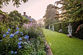 COTTESBROOKE HALL AND GARDENS, NORTHAMPTONSHIRE: STATUE WALK, DAWN, BORDERS, PHLOX PANICULATA COOL OF THE EVENING, DELPHINIUN PINK RUFFLES, VERONICASTRUM VIRGINICUM ALBUM