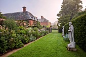 COTTESBROOKE HALL AND GARDENS, NORTHAMPTONSHIRE: STATUE WALK, DAWN, BORDERS, DELPHINIUN PINK RUFFLES, VERONICASTRUM VIRGINICUM ALBUM