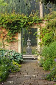 COTTESBROOKE HALL AND GARDENS, NORTHAMPTONSHIRE: THE TERRACE, DOUBLE HERBACEOUS BORDERS, GATE, OPENING, FOCAL POINT, URN, CONTAINER, HOSTAS