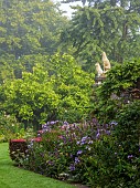 COTTESBROOKE HALL AND GARDENS, NORTHAMPTONSHIRE: BORDER BESIDE THE ENTRANCE TO THE POOLO GARDEN