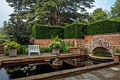 COTTESBROOKE HALL AND GARDENS, NORTHAMPTONSHIRE: THE MONKEY POOL, HYDRANGEA MACROPHYLLA MADAME EMILE MOUILLERE BESIDE THE POOL, WATER, WHITE BENCHES