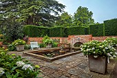 COTTESBROOKE HALL AND GARDENS, NORTHAMPTONSHIRE: THE MONKEY POOL, HYDRANGEA MACROPHYLLA MADAME EMILE MOUILLERE BESIDE THE POOL, WATER, WHITE BENCHES