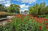 JUNE BLAKES GARDEN, IRELAND: JULY, RED BORDER, MONARDA JACOB CLINE, CROCOSMIA, HOT COLOURS