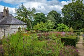JUNE BLAKES GARDEN, IRELAND: JULY, HOT BORDER, YEW HEDGING, HEDGES, MONARDAS