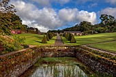 PLAS CADNANT, WALES: VIEW UP MAIN GARDEN, POND, POOL, PATH, CLIPPED TOPIARY YEW, LAWN, JULY