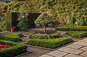 PLAS CADNANT, WALES: SMALL PARTERRE, CLIPPED STANDARD HOLLY, ILEX, LOW BOX HEDGES, HEDGING, JULY