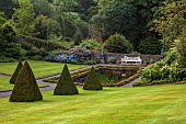 PLAS CADNANT, WALES: PATH, LAWN, JULY, CLIPPED TOPIARY YEW, WALLED GARDEN, POOL, POND, WOODEN BENCH, SEAT
