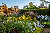 ROCKINGHAM CASTLE, NORTHAMPTONSHIRE: BORDER, SEAT, BENCH, SCABIOSA PERFECTION BLUE, GLADIOLUS EVERGREEN, HEMEROCALLIS GOLDEN CHIMES, RUDBECKIA AUTUMN FOREST, WEIGELIA
