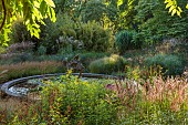 KNOLL GARDENS, DORSET: SEPTEMBER, GRASSES, THE DRAGON GARDEN, POND, POOL, WATER, SCULPTURE, FOUNTAIN