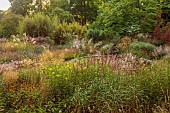 KNOLL GARDENS, DORSET: SEPTEMBER, THE DRAGON GARDEN, ORNAMENTAL GRASSES, PERENNIALS, POND, POOL, FOUNTAIN