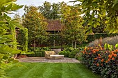 PRIVATE GARDEN, BERKSHIRE: ISTVAN DUDAS: LAWN, SEAT, BORDER, DAHLIA DAVID HOWARD, CANNA MUSIFOLIA, LAVANDULA VERA, SALVIA AMISTAD, TERRACE, CLIPPED BOX, HYDRANGEA ANNABELLE