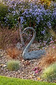 JOHN MASSEY GARDEN, ASHWOOD NURSERIES, WORCESTERSHIRE: SEPTEMBER, GRAVEL, SYMPHYOTRICHUM LITTLE CARLOW, SWAN SCULPTURE