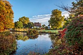LLANOVER GARDEN, MONMOUTHSHIRE: OCTOBER, VIEW ACROSS THE UPPER POND TOWARDS THE HOUSE AND DOVECOTE, WATER, FALL, AUTUMN