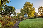 LLANOVER GARDEN, MONMOUTHSHIRE: WALLED, ROUND GARDEN, OCTOBER, BORDER, LAWN, PATH, DOVECOTE, ACER GRISEUM, GRASSES, PERENNIALS