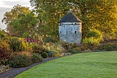 LLANOVER GARDEN, MONMOUTHSHIRE: WALLED, ROUND GARDEN, OCTOBER, BORDER, LAWN, PATH, DOVECOTE, GRASSES, PERENNIALS, SALVIAS, DAHLIA DAVID HOWARD